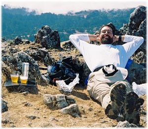 Steve resting, with a beer at hand, on the summit of Black Mountain