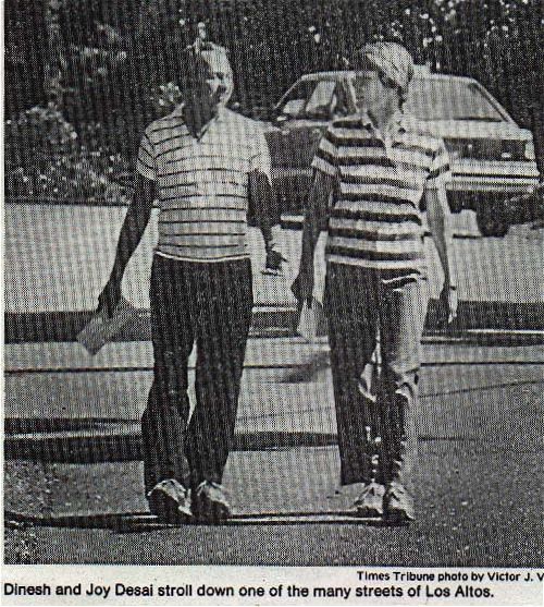 a scan of a newspaper photograph: Dinesh and Joy stroll down one of the many streets of Los Altos