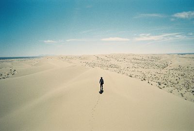 looking down on a hiker walking on a dune ridge