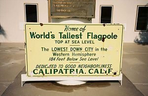 A sign announcing 'Home of World's Tallest Flagpole'