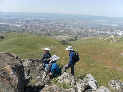 three hikers on a summit