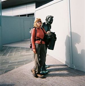 Joy standing next to a life-sized bronze statue