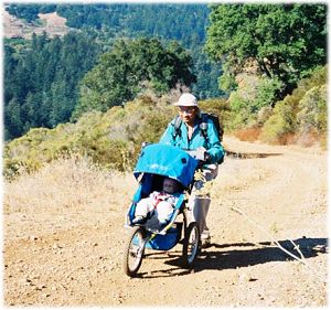 Dinesh pushing Lando in his stroller up a hill