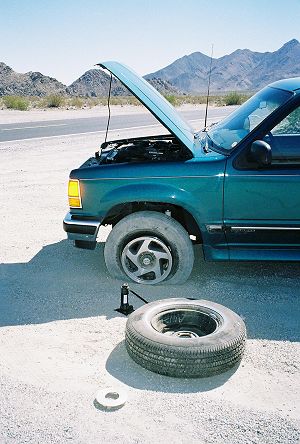 SUV, flat tire, and spare