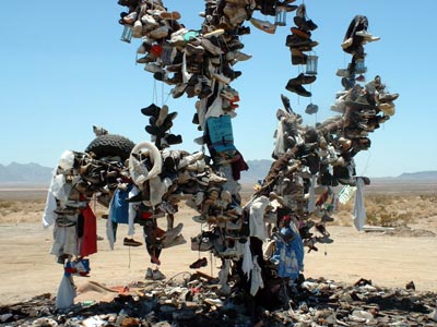 a tree with shoes and other artifacts attached to it