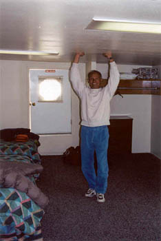 Dinesh displaying the low ceiling in the motel room